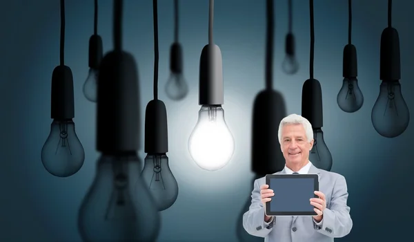 Mature businessman showing his tablet — Stock Photo, Image