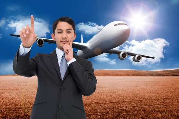 Thoughtful asian businessman pointing — Stock Photo, Image
