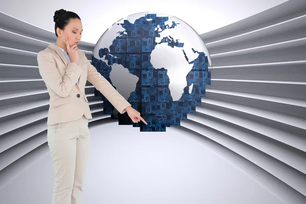 Composite image of thoughtful asian businesswoman pointing — Stock Photo, Image