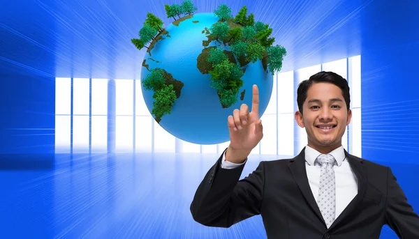 Composite image of smiling asian businessman pointing — Stock Photo, Image