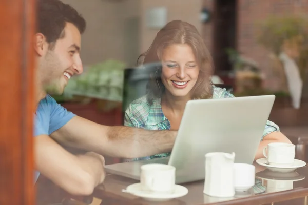 Two laughing students looking at laptop — Stock Photo, Image
