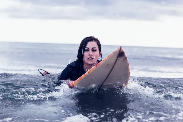水の中でサーフボードの上に泳いで女性の肖像 — ストック写真