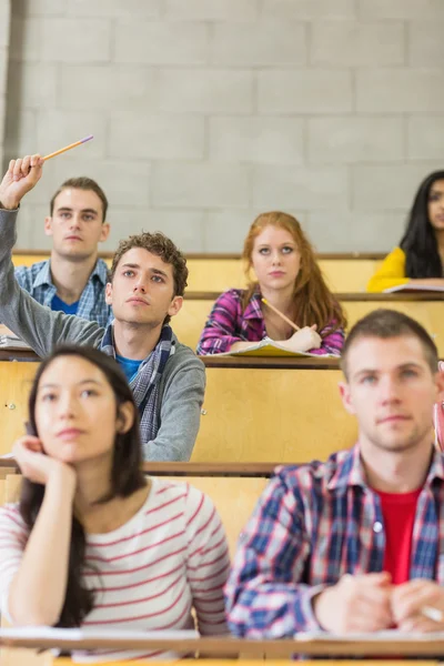 Concentrating students sitting at lecture hall Stock Photo