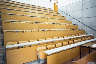 Empty seats with tables in a lecture hall clipart