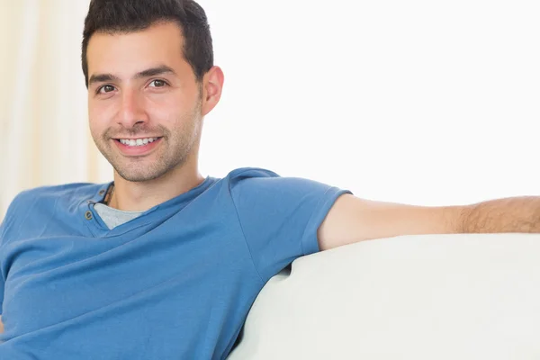 Casual attractive man relaxing on couch — Stock Photo, Image