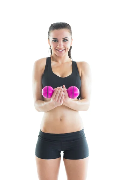 Portrait of happy active woman training using a pink dumbbell — Stock Photo, Image