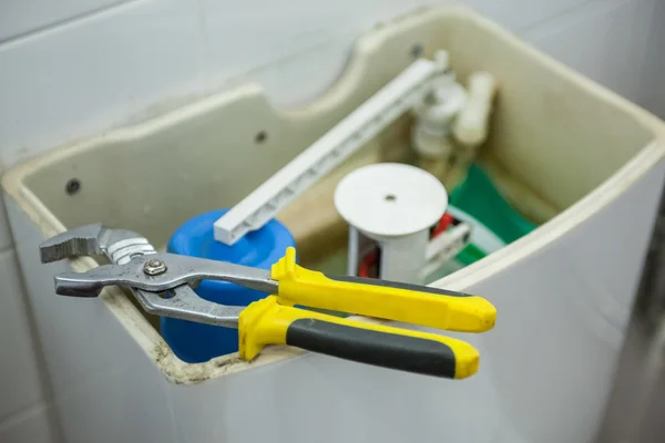 Close up of pliers lying on toilet — Stock Photo, Image