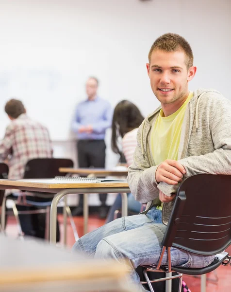 Male with blurred teachers students in classroom — Stock Photo, Image