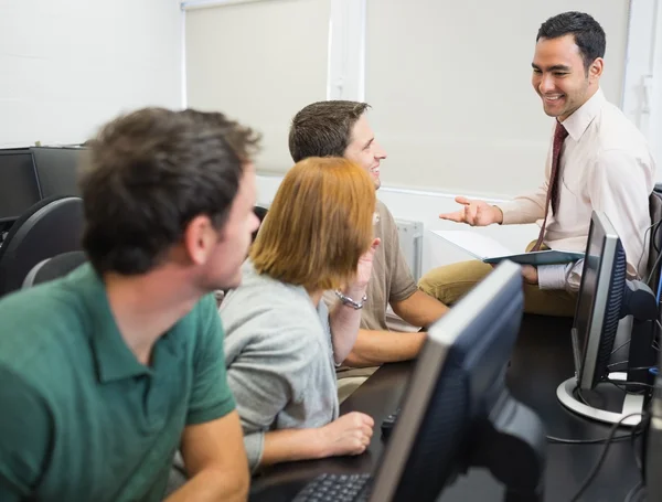 Leraar en volwassen studenten in computerlokaal — Stockfoto