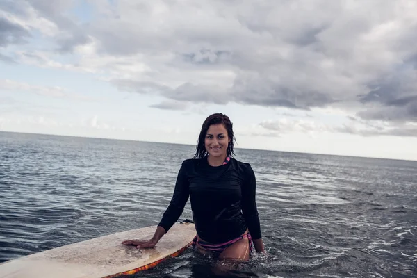 Retrato de una hermosa mujer con tabla de surf en agua —  Fotos de Stock