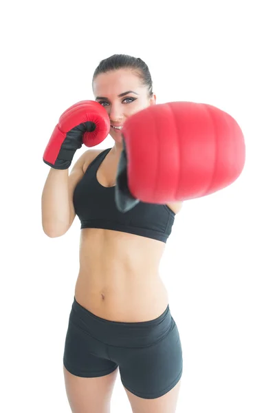 Beautiful sporty woman posing wearing red boxing gloves — Stock Photo, Image