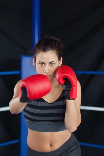 Portrait of a beautiful woman in red boxing gloves — Stock Photo, Image