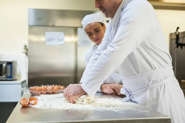 Serious head chef kneading dough — Stock Photo, Image