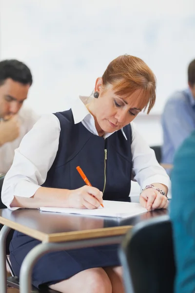 Koncentrerad kvinna mogen student sitter i klassrummet — Stockfoto