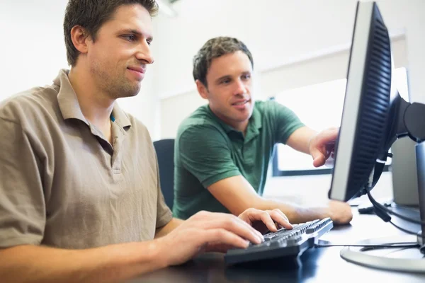 Teacher and mature student in computer room — Stock Photo, Image