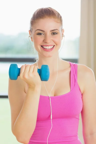 Cheerful woman exercising with dumbbells in fitness studio — Stock Photo, Image