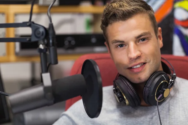 Handsome smiling singer recording a song — Stock Photo, Image