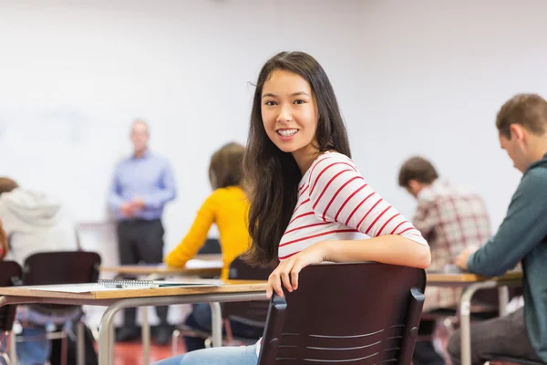 Female with blurred teachers students in classroom — Stock Photo, Image