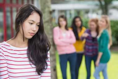 Student being bullied by a group of students clipart