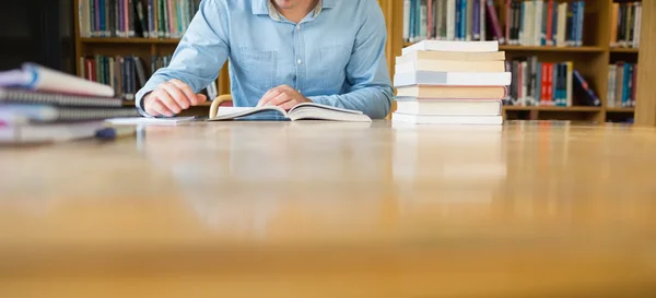 Střední sekce student studuje na knihovna desk — Stock fotografie