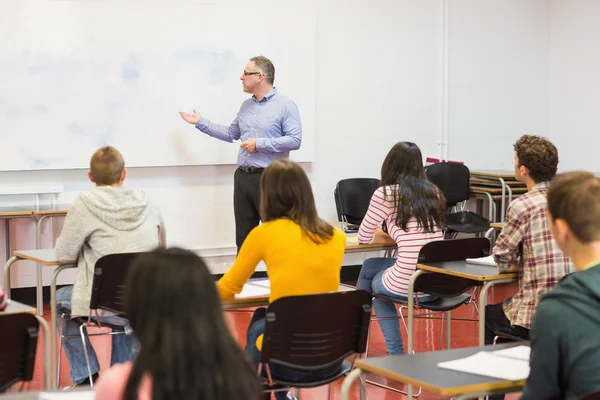 Attentive students with teacher in the classroom — Stock Photo, Image