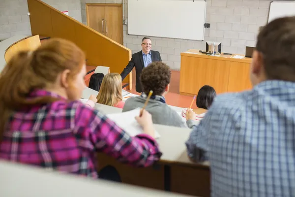 Teacher with students at the lecture hall — Stock Photo, Image