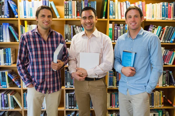 Sorrindo estudantes maduros juntos na biblioteca — Fotografia de Stock