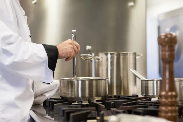 Head chef stirring in pot — Stock Photo, Image