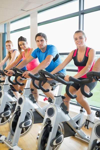 Quatre personnes s'entraînent en cours de spinning — Photo