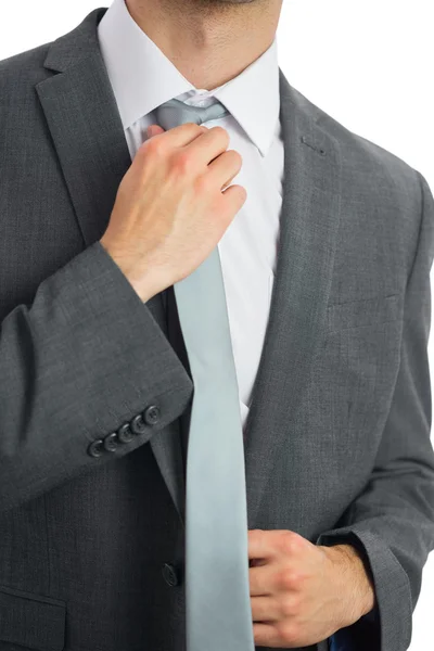 Close up of businessman adjusting blue tie — Stock Photo, Image