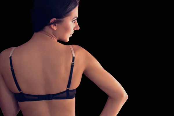 Vue arrière de magnifique jeune femme portant de la lingerie sombre — Photo