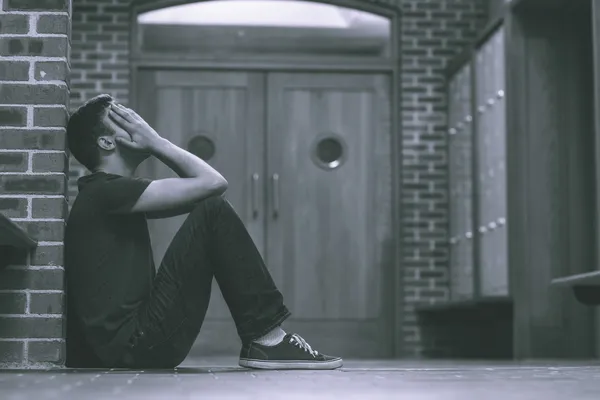 Unhappy handsome student in pain having a headache — Stock Photo, Image