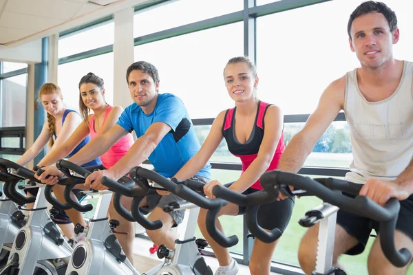 People working out at spinning class Stock Image
