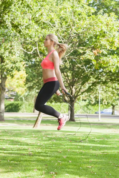 Side view of sporty woman skipping — Stock Photo, Image