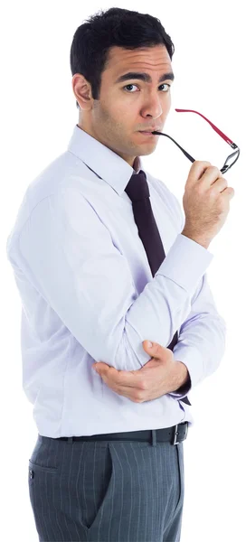 Unsmiling businessman holding glasses — Stock Photo, Image