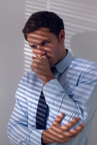 Elegant businessman with a cough against the wall — Stock Photo, Image