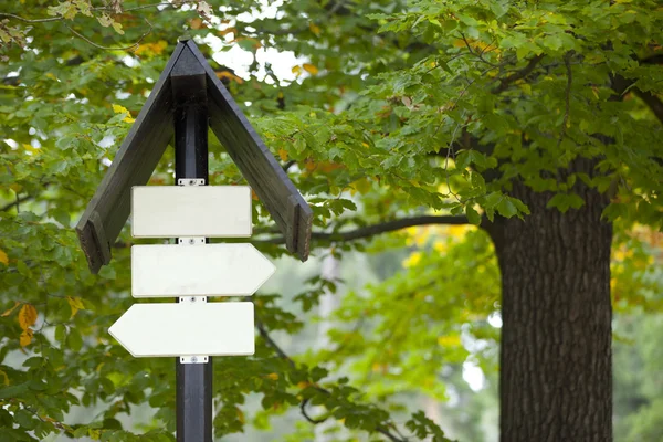 Blank sign boards against trees — Stock Photo, Image