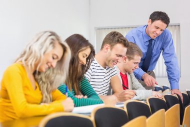 Teacher with college students in the classroom clipart