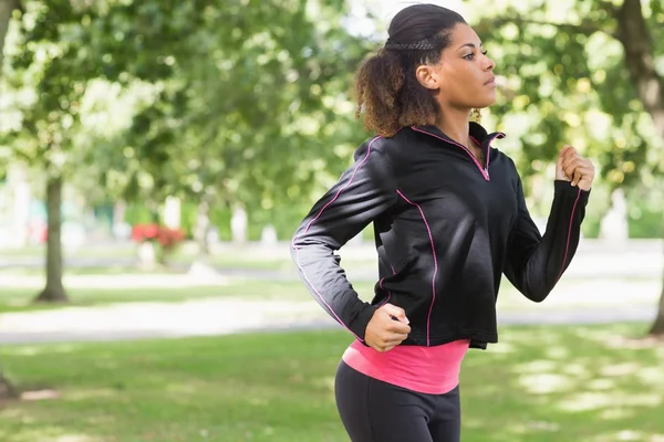 Güzel, sağlıklı bir kadın Park'ta jogging yan görünüm — Stok fotoğraf