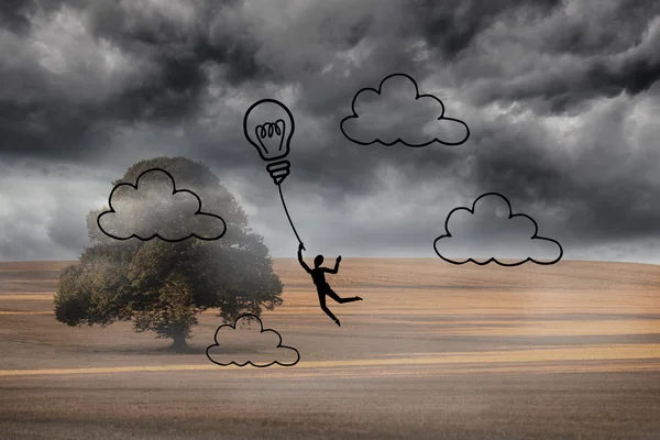 Gloeilamp ballon over bewolkt landschap — Stockfoto