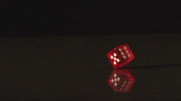 Red dice revolving on black background — Stock Video