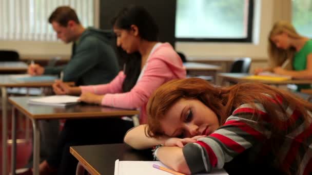 Studentin schläft im Unterricht am Schreibtisch — Stockvideo