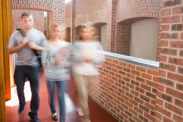 Opiskelijat kävelevät käytävällä yhdessä — kuvapankkivalokuva