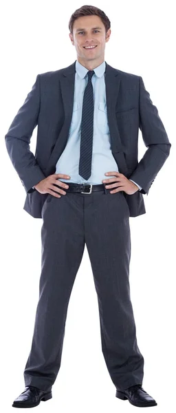 Smiling businessman with hands on hips — Stock Photo, Image