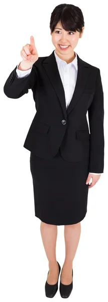 Smiling businesswoman pointing — Stock Photo, Image