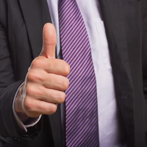 Businessman in suit gesturing thumbs up — Stock Photo, Image