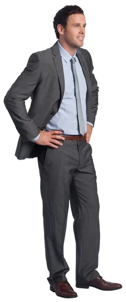 Smiling businessman with hands on hips — Stock Photo, Image