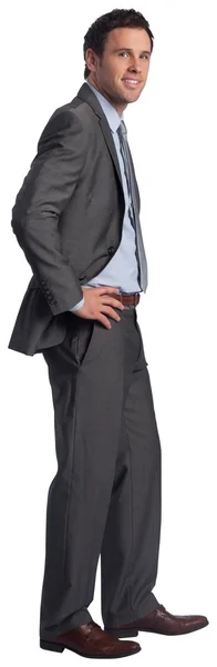 Smiling businessman with hands on hips — Stock Photo, Image