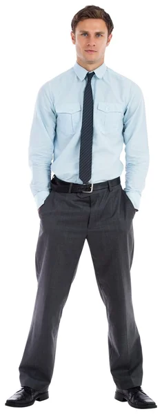 Serious businessman standing with hands in pockets — Stock Photo, Image