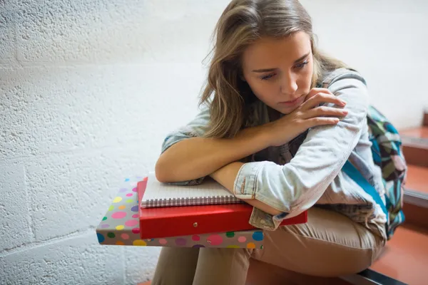 Sad student sitting on stairs — Stock Photo, Image